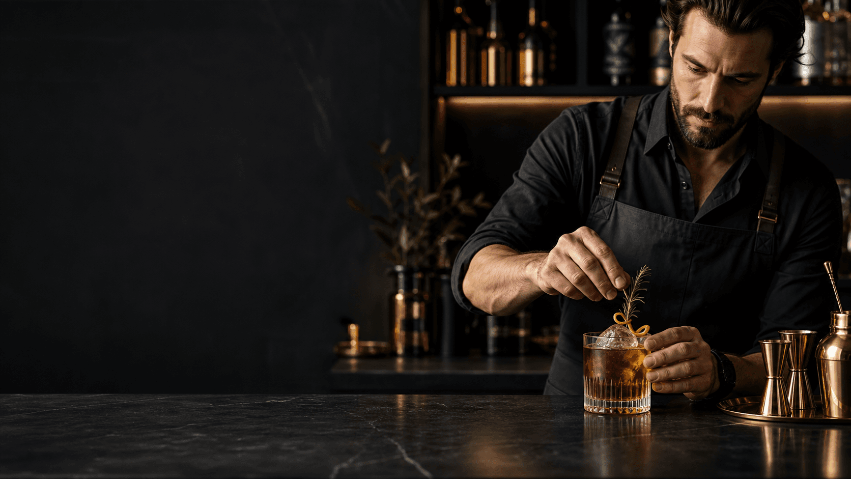 Mixologist finishing an amber signature cocktail