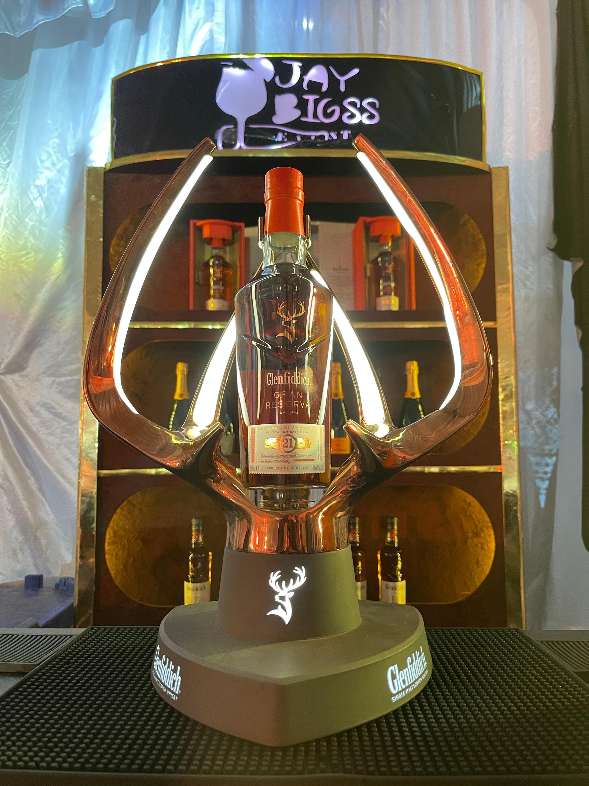 Mixologist finishing an amber signature cocktail