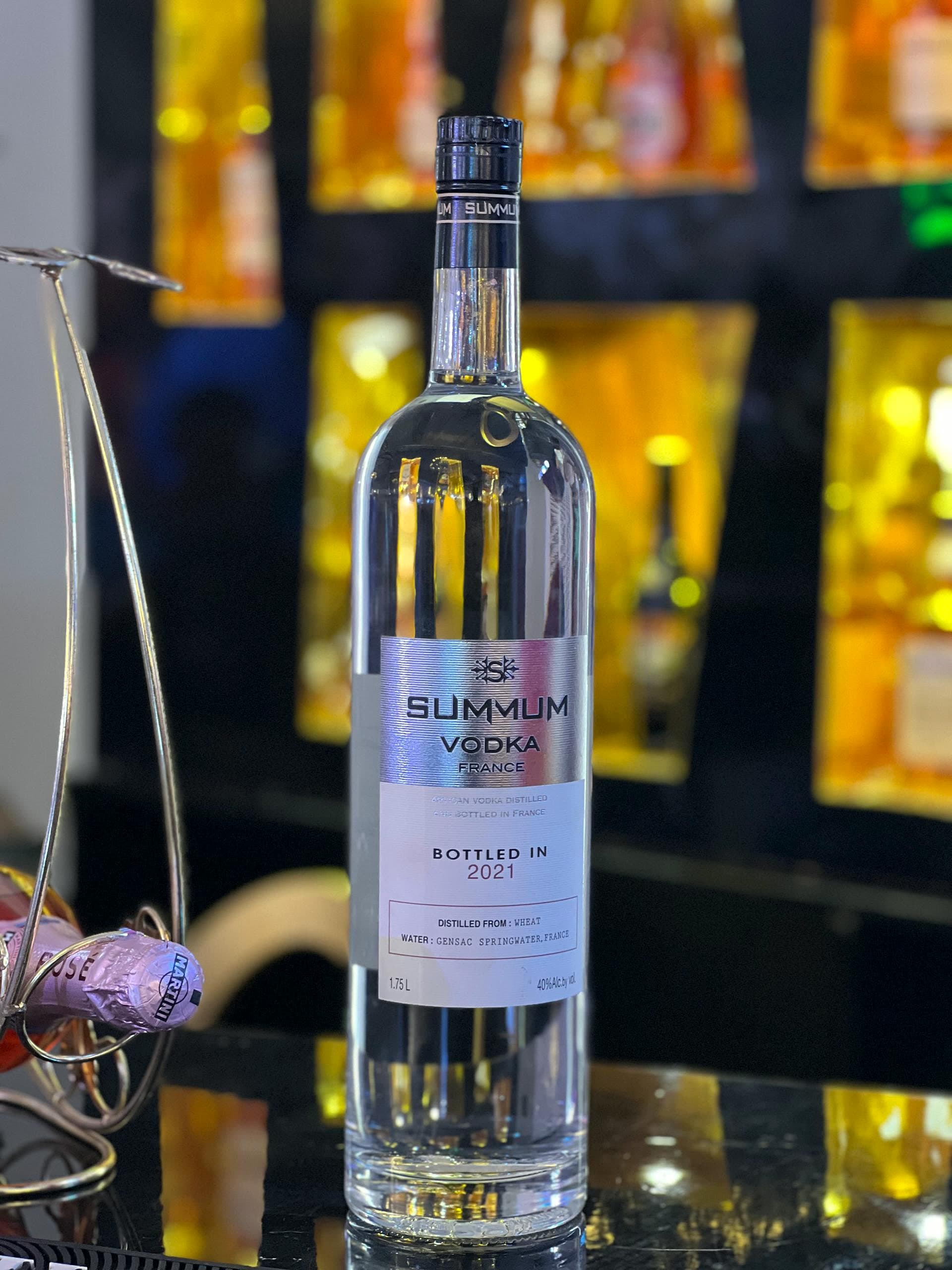 A bottle of Summum vodka staged on the bar during live event execution