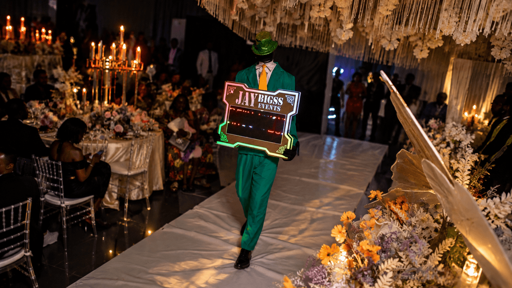 Branded Jay Bigss bar cart fully stocked with premium spirits under a lit BAR marquee sign